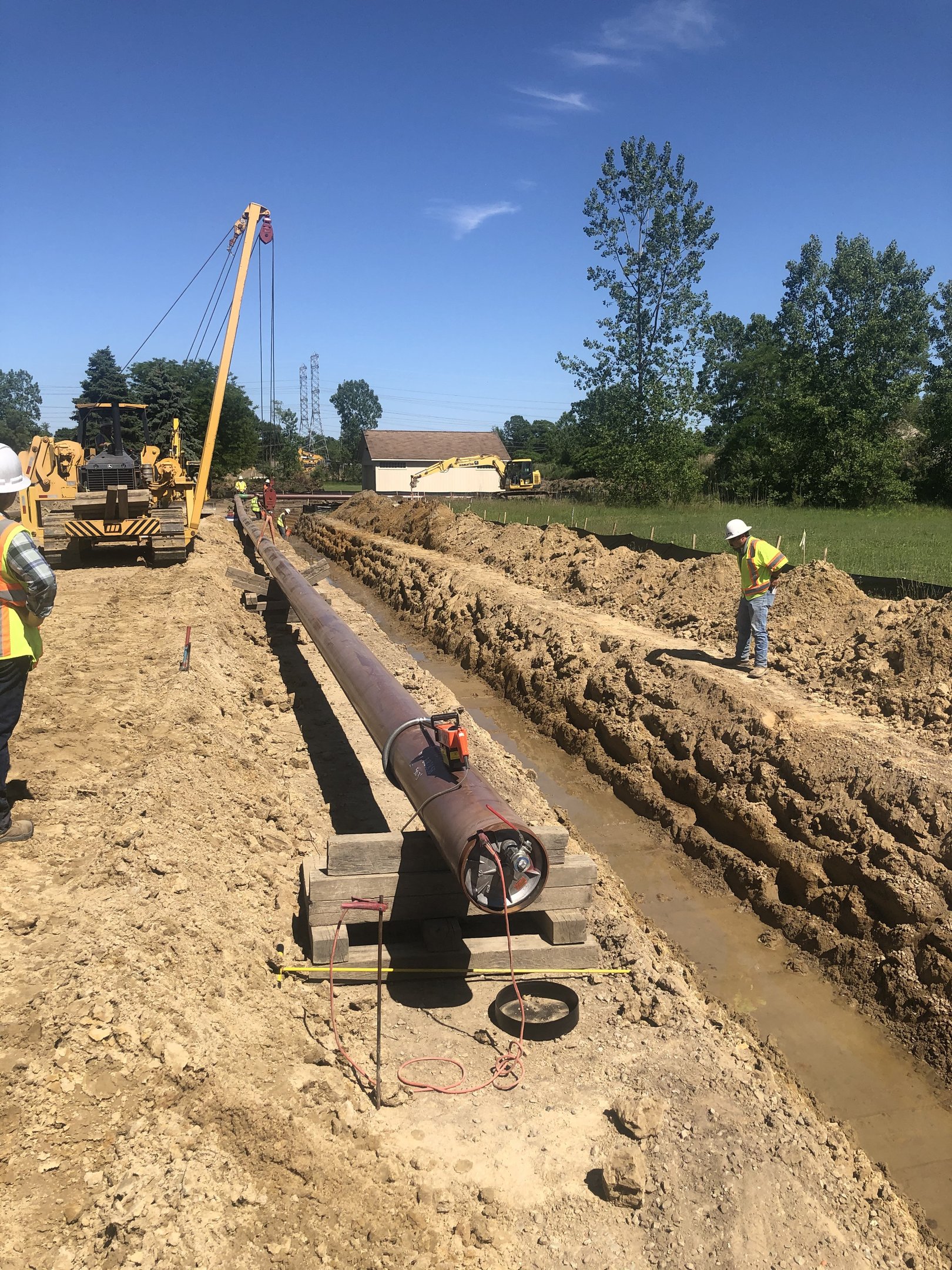 Open-cut pipeline and sideboom in a field, Eastern Michigan.