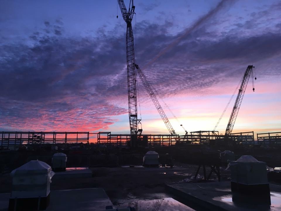 Lattice boom crawler cranes at dusk on an LNG new build, SW Louisiana.